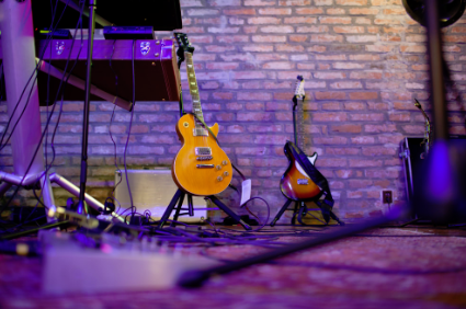 This is a picture of two nice guitars on a stage.