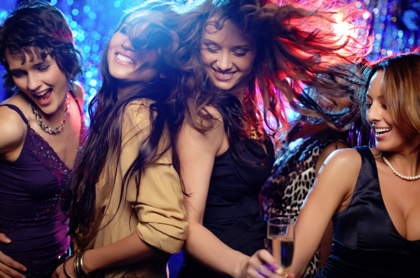 This is a picture of four woman dancing and having fun at a Calgary DJ Corporate party.