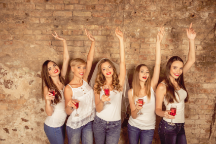 This is a picture of five ladies posing with drinks at a stagette party.